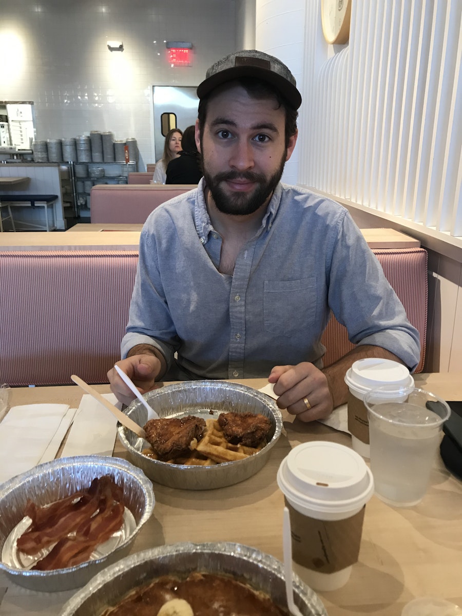 Lane having chicken and waffles at a local diner